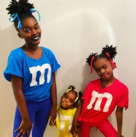 Melody Hurd, Lyric Hurd, and Rhythm Hurd are posing for the photo. 